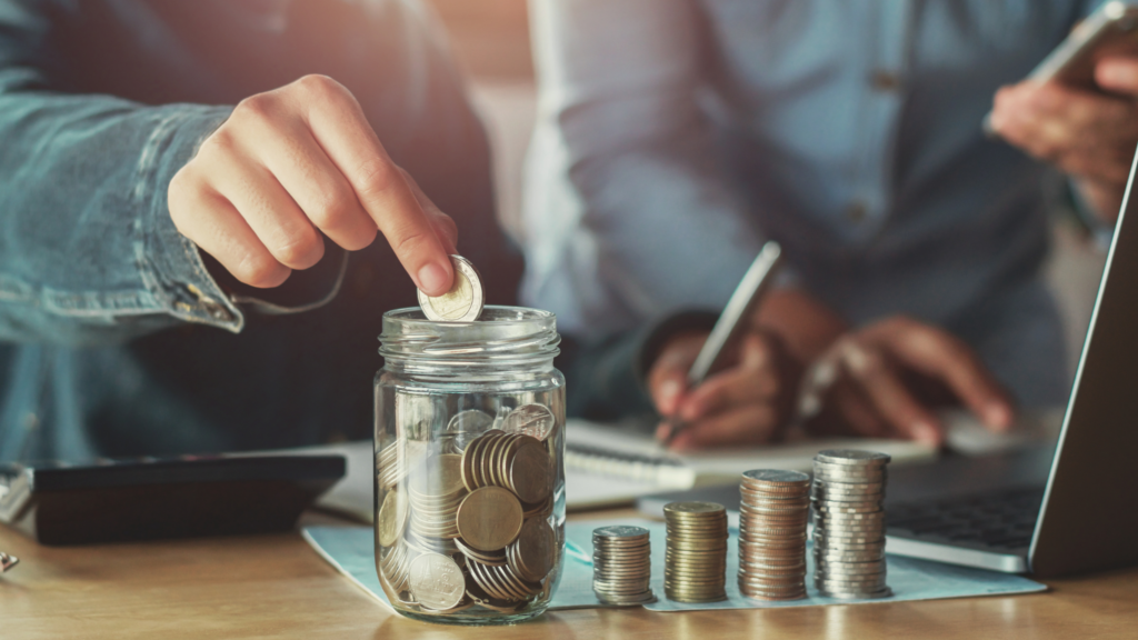 Man counting coins and placing them in a jar