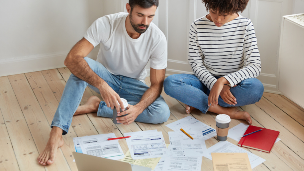 Couple looking at a pile of bills