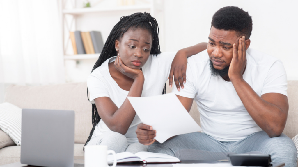 Frustrated couple looking at a document