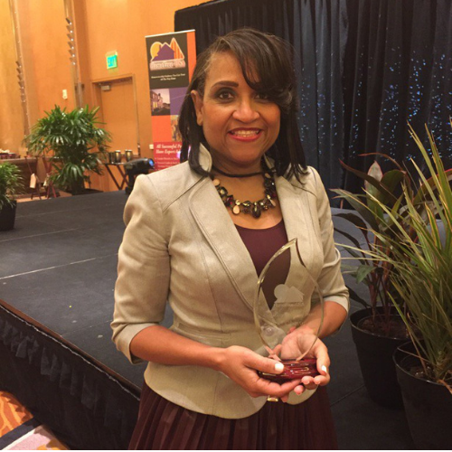 Connie Wright holding an award