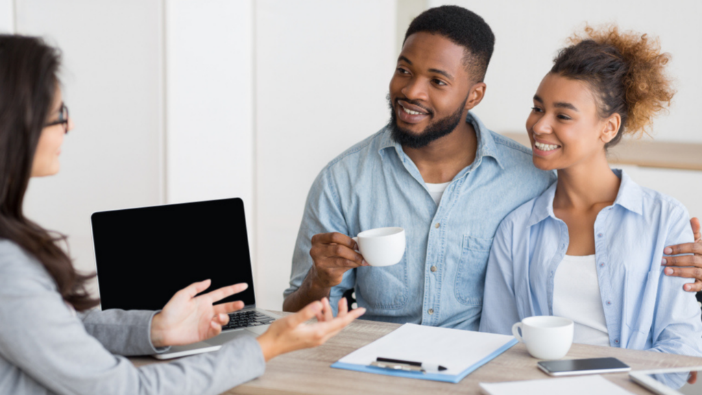 African American couple speaking with a mortgage professional