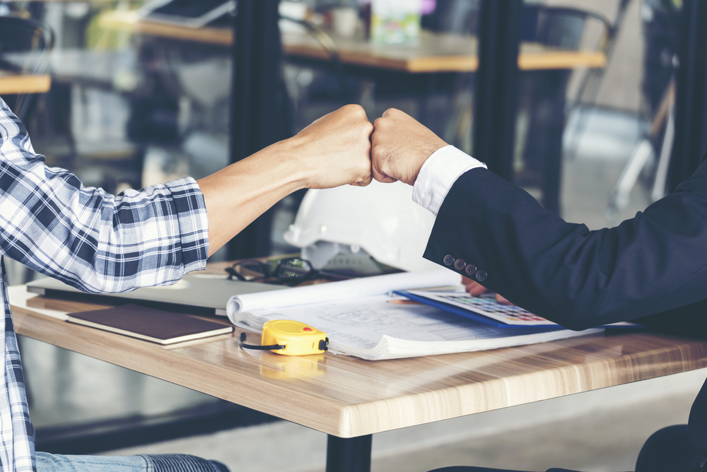 Two people fist bumping
