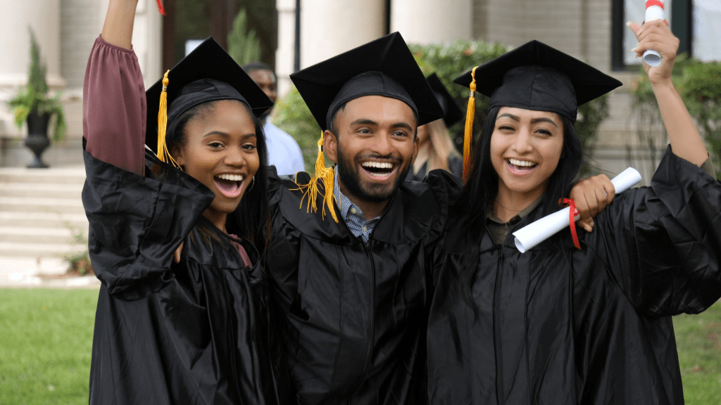 Three students in graduation cap and gowns.