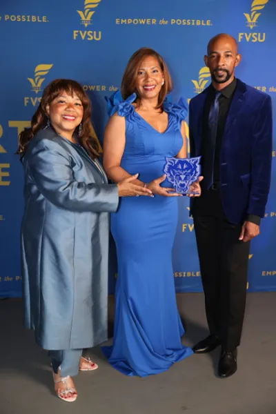 One award recipient and two people at Diner en Bleu awards event