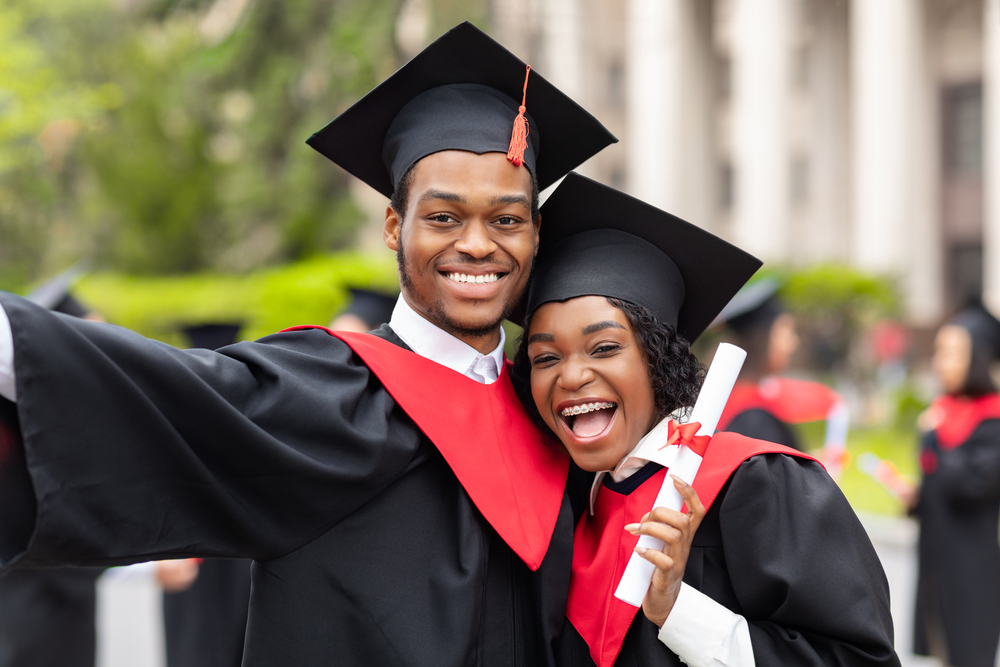 Two African American graduates smiling
